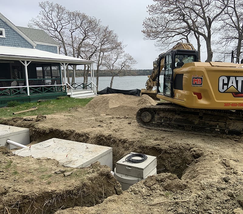 installation of a septic system with an excavator